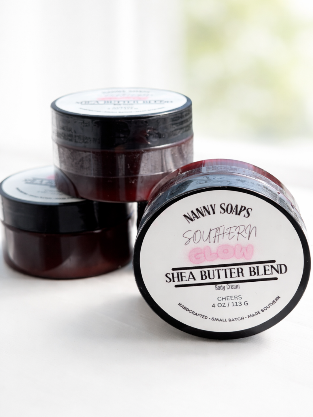 Two jars of Nanny Soaps Southern Glow Shea Butter Blend on a white background