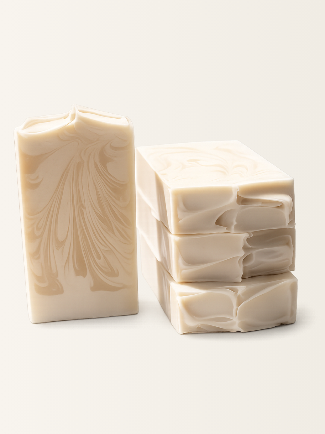 Three bars of swirled beige soap on a white background