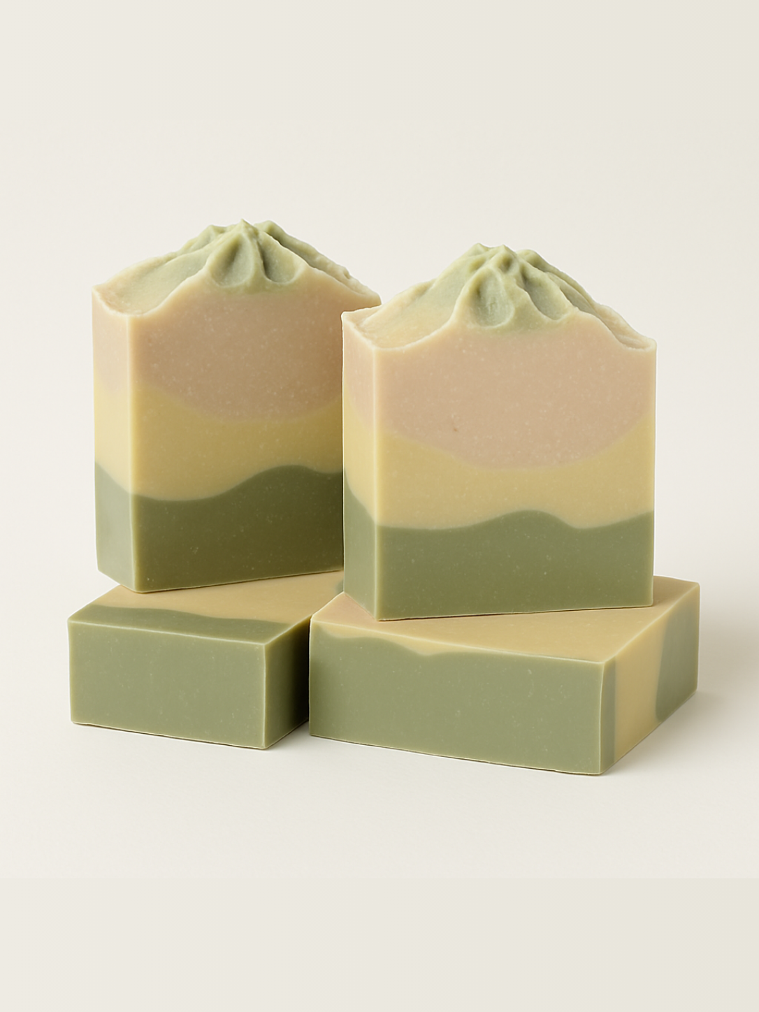 Stack of green layered soap bars on a light background