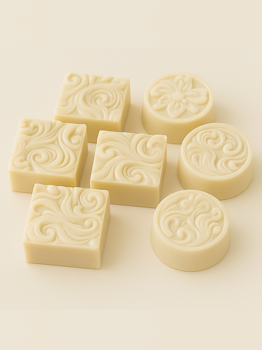 Decorative soap bars with intricate patterns on a light background