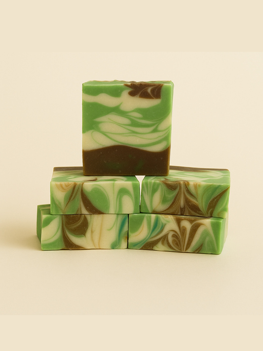 Stack of green and brown marbled soap bars on a beige background