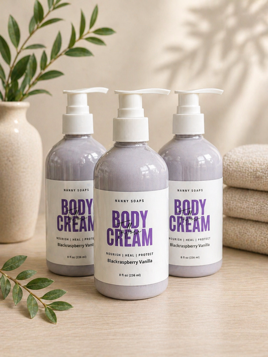 Blackraspberry Vanilla scented Tallow Body Cream on a wooden surface with green leaves and towels in the background.