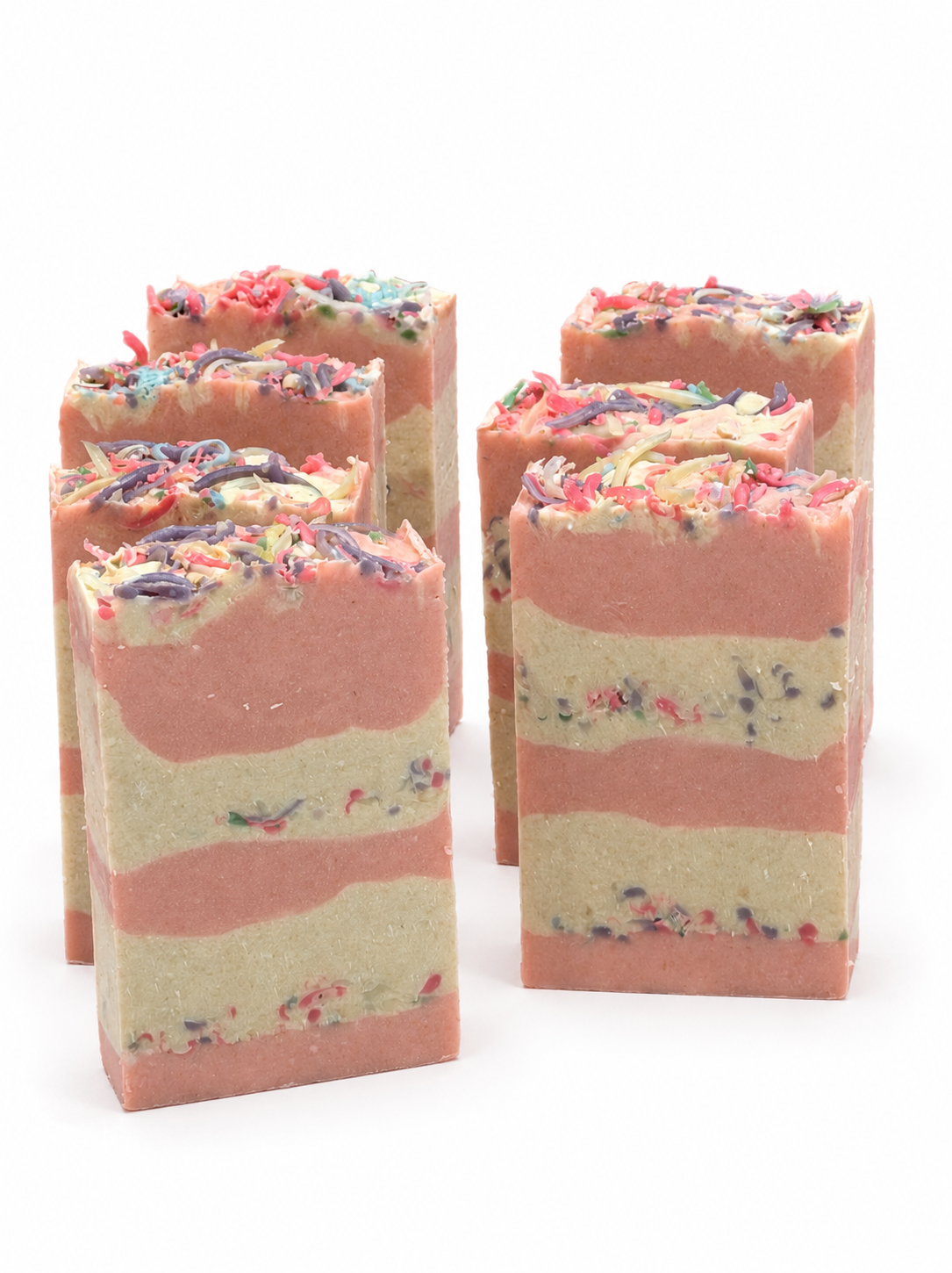 Five layered soap bars with colorful sprinkles on a white background
